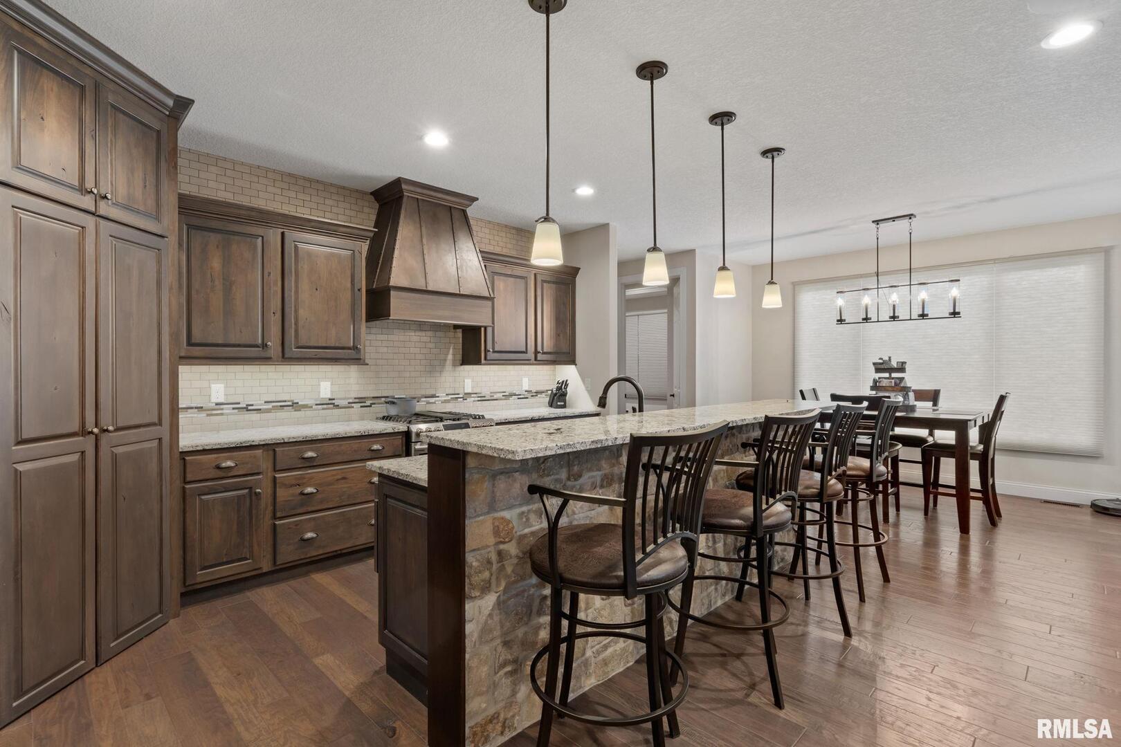 1422 Racine Court Davenport, IA 52804 - Photo 13 of 53 a kitchen with granite countertop a sink appliances and chairs