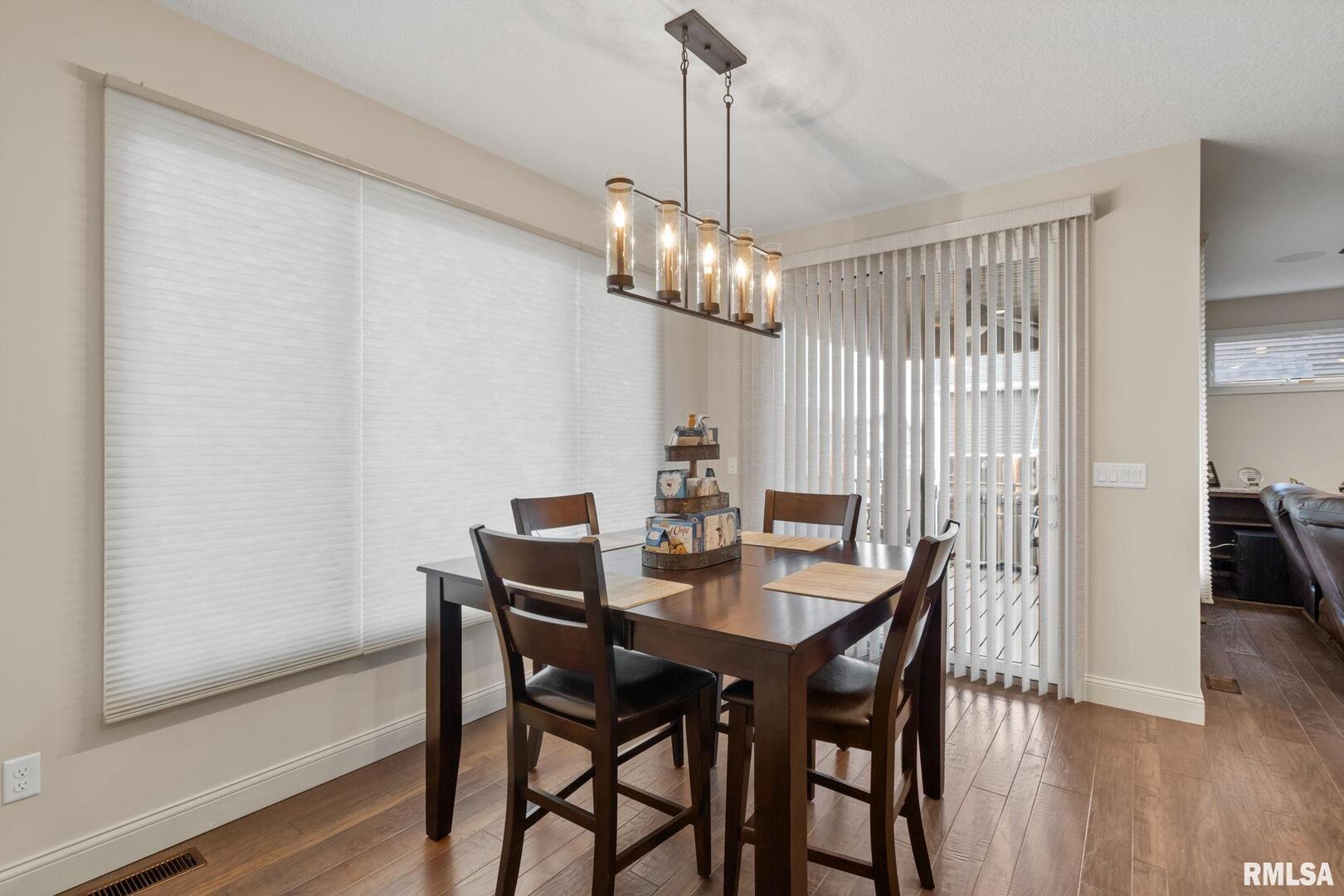 1422 Racine Court Davenport, IA 52804 - Photo 16 of 53 a view of a dining room with furniture window and wooden floor
