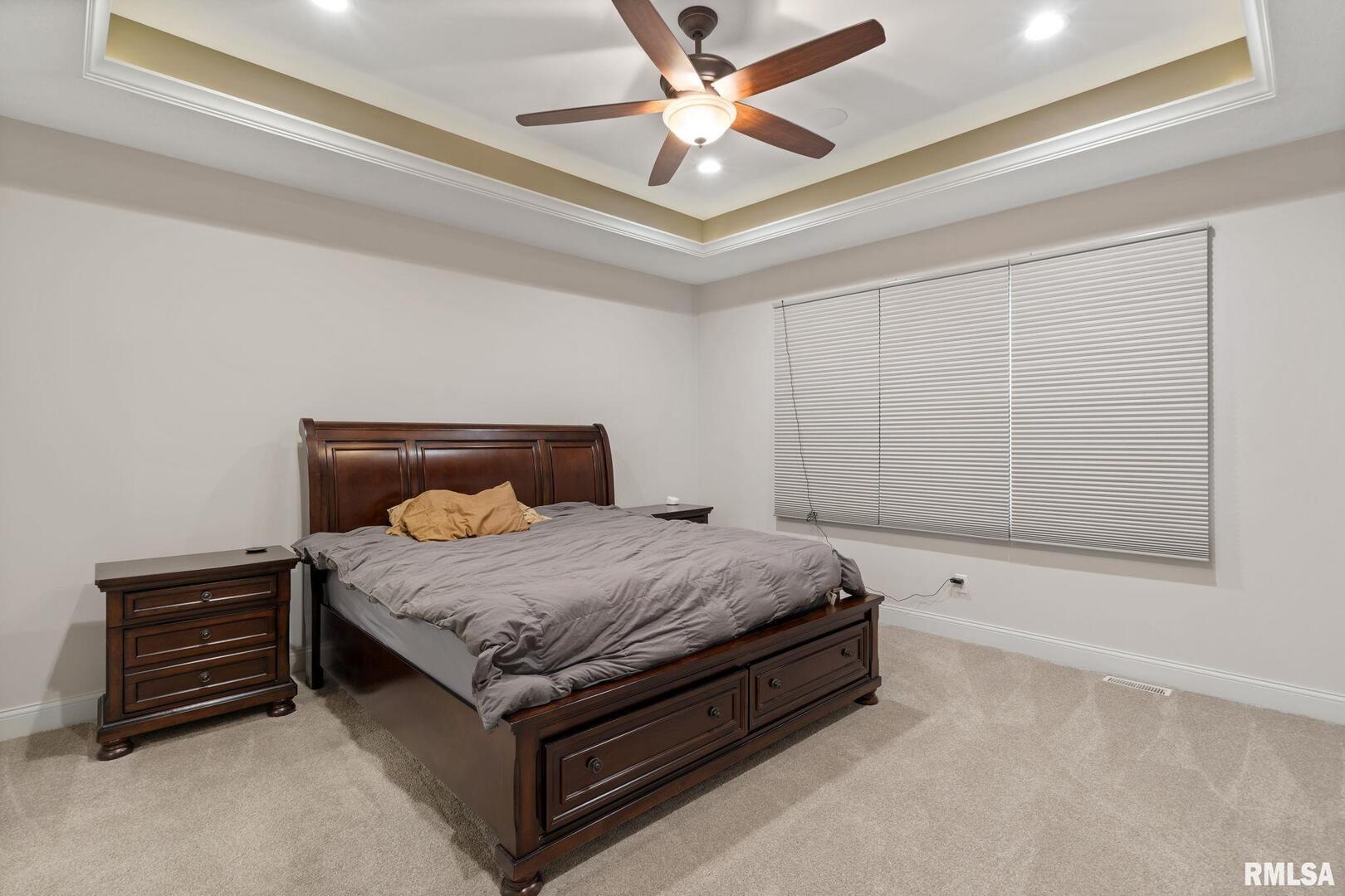 1422 Racine Court Davenport, IA 52804 - Photo 18 of 53 a bedroom with a bed and a ceiling fan