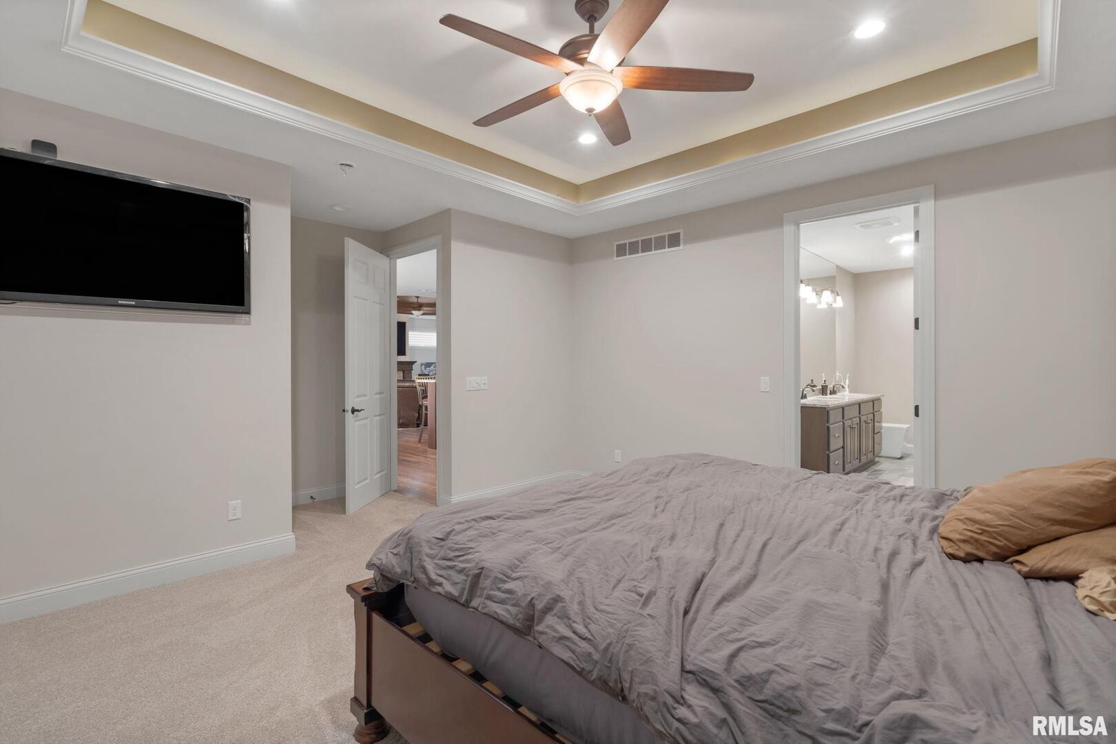 1422 Racine Court Davenport, IA 52804 - Photo 19 of 53 a bedroom with a bed and a flat tv screen on dresser