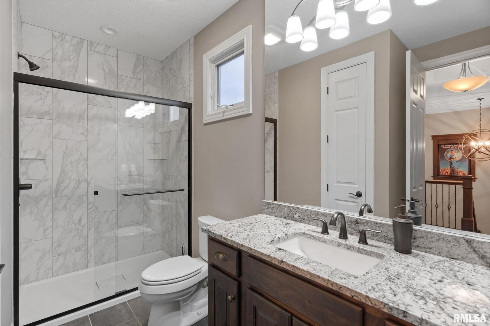 1422 Racine Court Davenport, IA 52804 - Photo 27 of 53 a bathroom with a granite countertop sink toilet mirror and shower