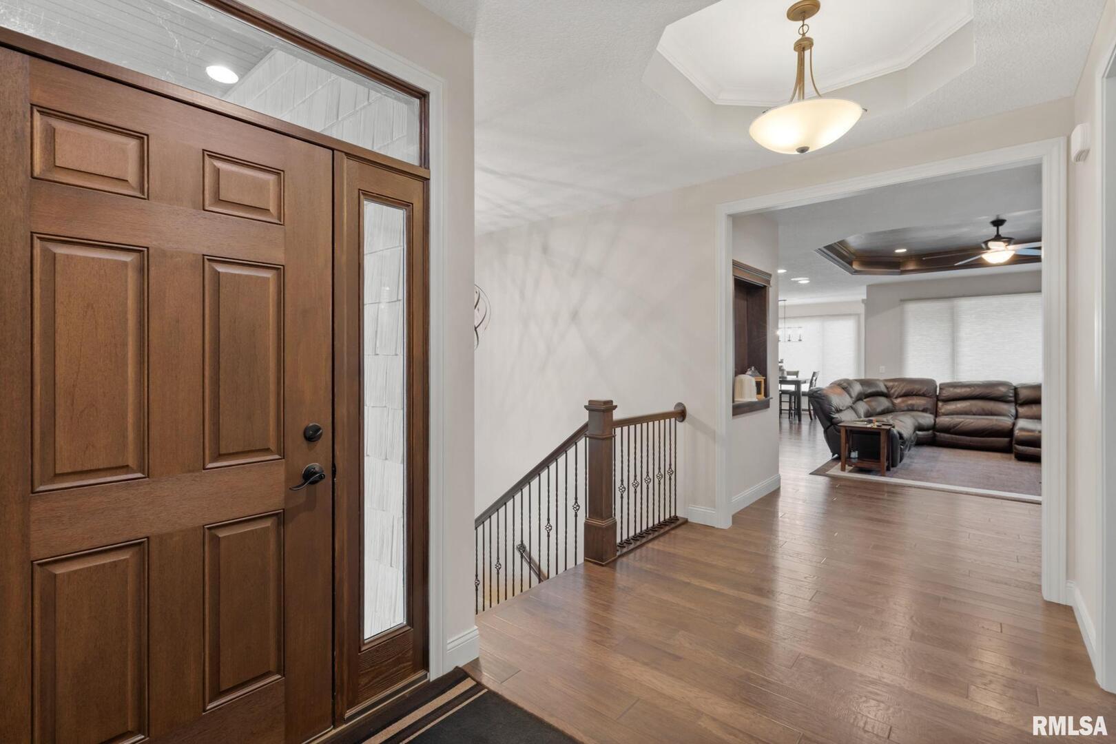 1422 Racine Court Davenport, IA 52804 - Photo 4 of 53 a view of a livingroom with furniture hardwood floor and a ceiling fan