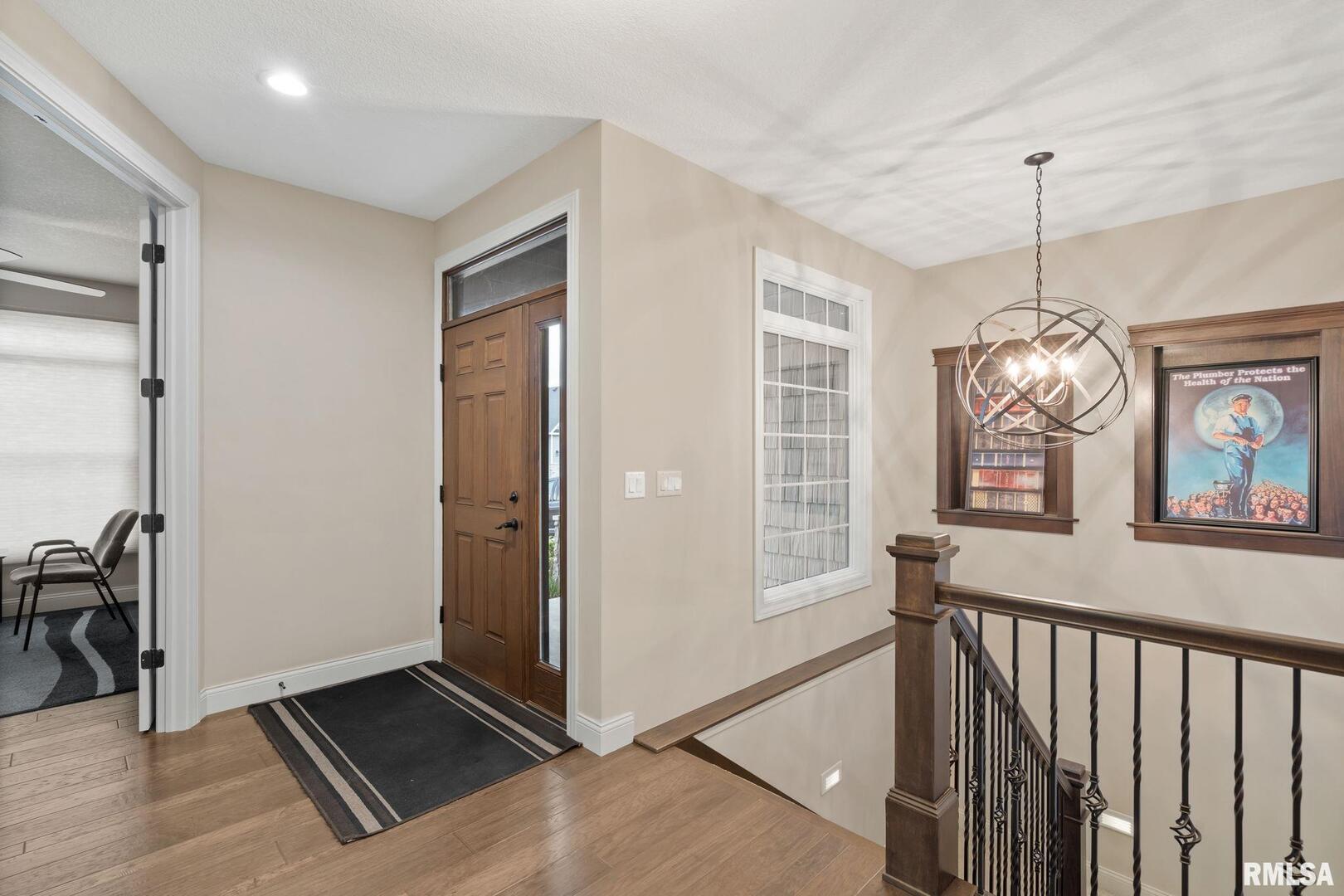 1422 Racine Court Davenport, IA 52804 - Photo 5 of 53 a view of a hallway with wooden floor and windows