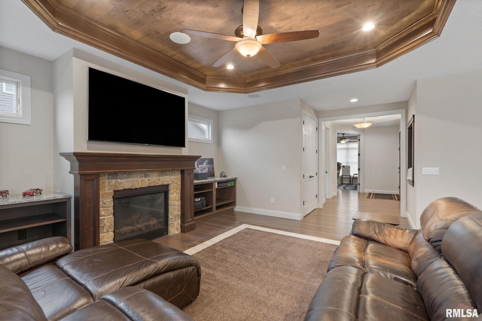 1422 Racine Court Davenport, IA 52804 - Photo 8 of 53 a living room with furniture a flat screen tv and a fireplace