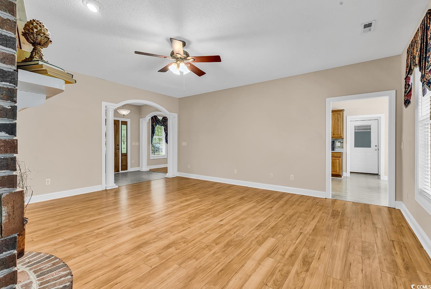 6161 Inman Circle Conway, SC 29526 - Photo 7 of 40 Unfurnished living room with ceiling fan, arched w