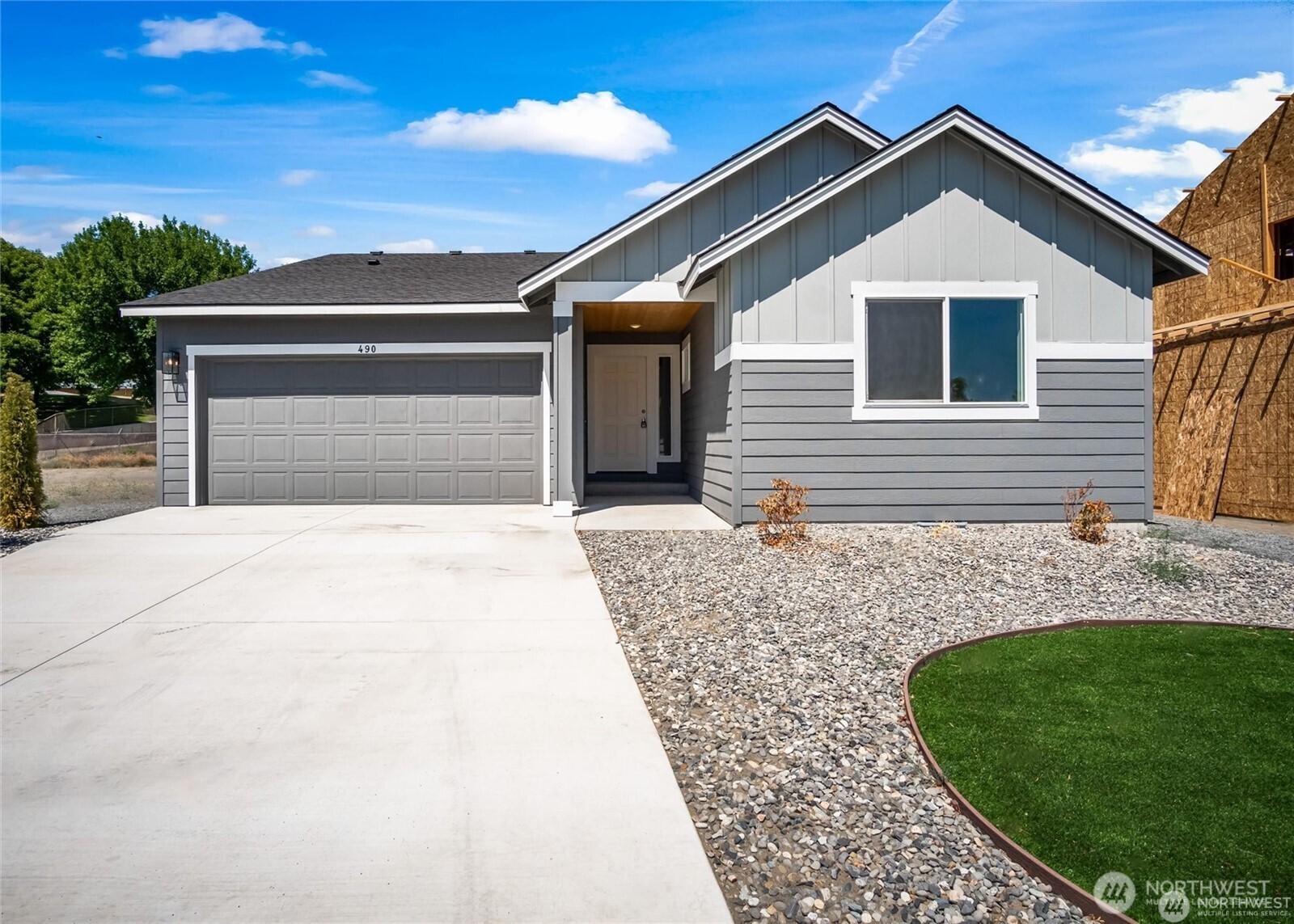 a front view of a house with a garden