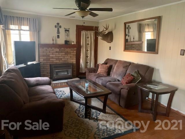 645 Thompson Cove Road Clyde, NC 28721 - Photo 5 of 12 a living room with furniture and a fireplace
