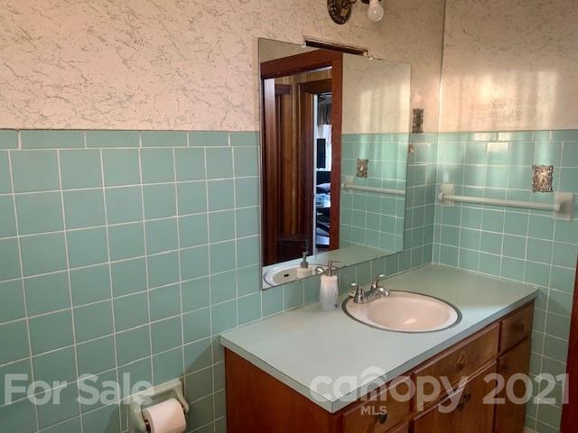645 Thompson Cove Road Clyde, NC 28721 - Photo 7 of 12 a bathroom with a sink and a mirror