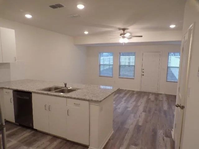 a kitchen with a sink and chandelier