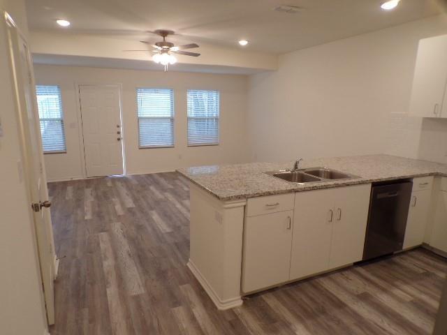 709 South 5th Street, Unit 2 Bonham, TX 75418 - Photo 3 of 32 a kitchen with a sink cabinets and wooden floor