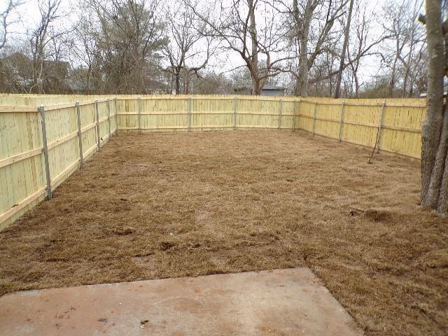 709 South 5th Street, Unit 2 Bonham, TX 75418 - Photo 31 of 32 a view of swimming pool with large trees and wooden fence