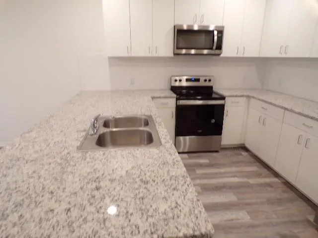 a kitchen with a stove and a white cabinets