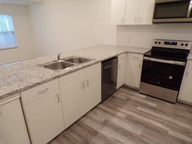 709 South 5th Street, Unit 2 Bonham, TX 75418 - Photo 5 of 32 a kitchen with a sink and a stove top oven