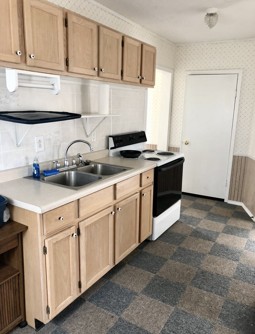 2021 7th Street Peru, IL 61354 - Photo 13 of 18 a kitchen with stainless steel appliances granite countertop a sink and a stove
