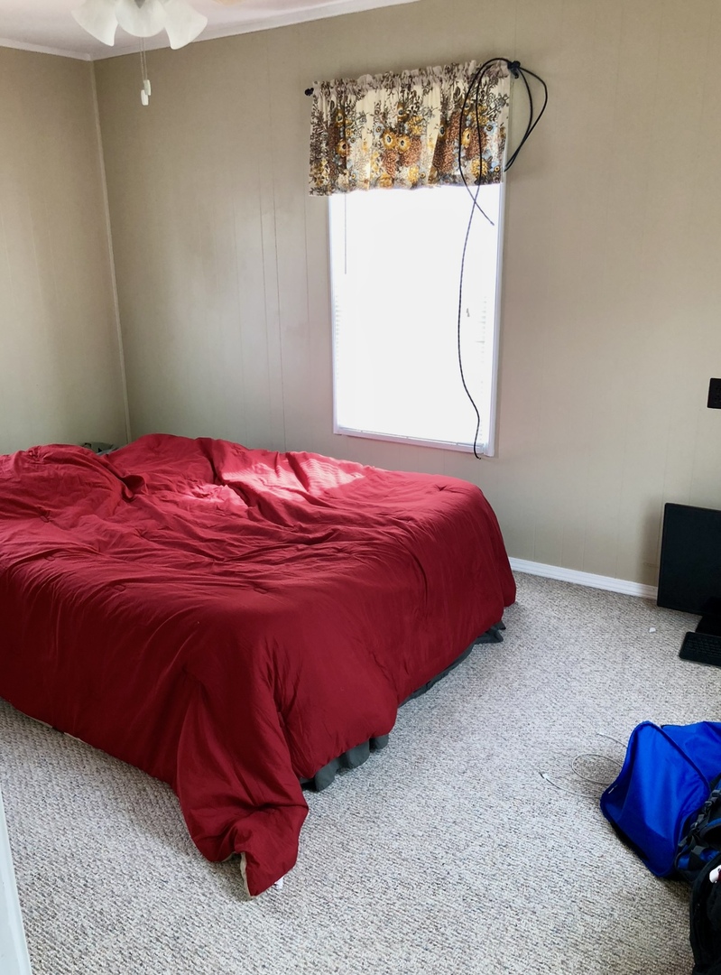 2021 7th Street Peru, IL 61354 - Photo 16 of 18 a bed sitting in a bedroom next to a window
