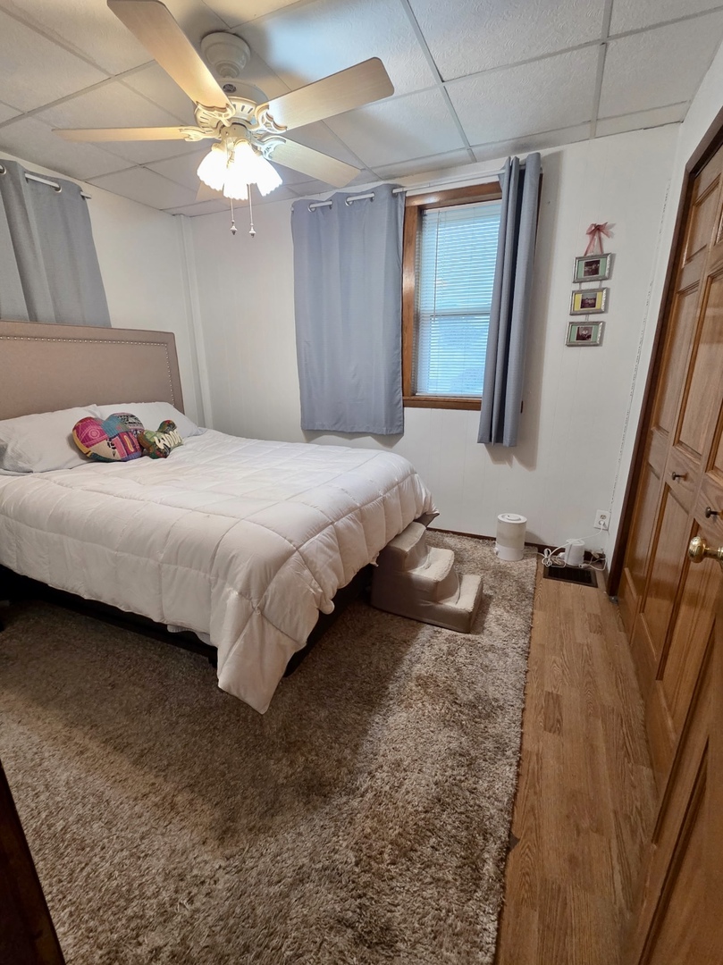 2021 7th Street Peru, IL 61354 - Photo 5 of 18 a bedroom with a bed chandelier and a window