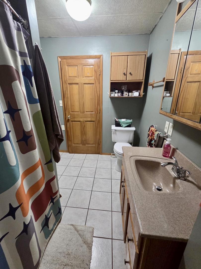 2021 7th Street Peru, IL 61354 - Photo 9 of 18 a bathroom with a sink toilet and shower