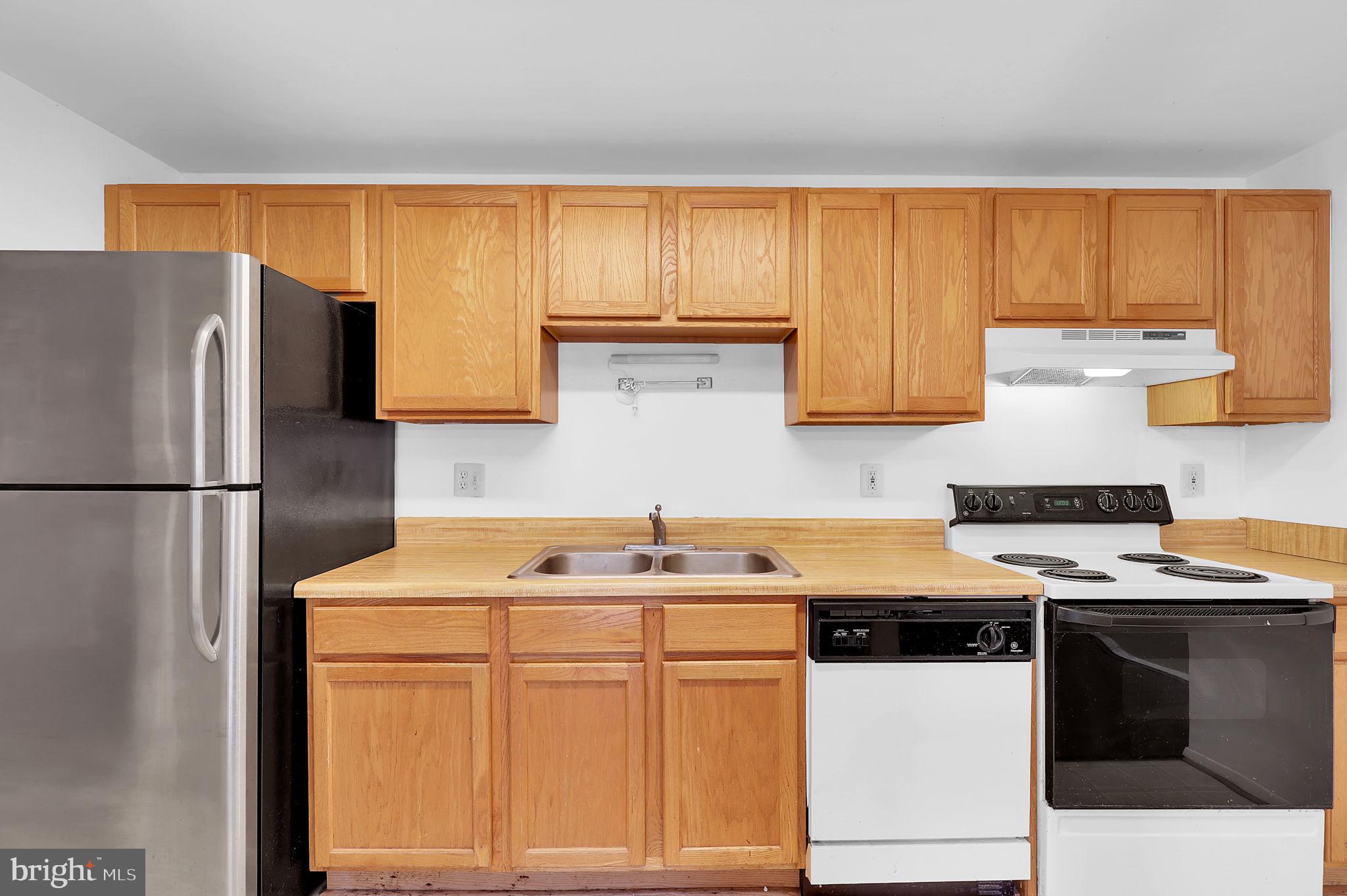 19625 Gunners Branch Road, Unit 932 Germantown, MD 20876 - Photo 11 of 21 a kitchen with stainless steel appliances granite countertop a sink stove and refrigerator