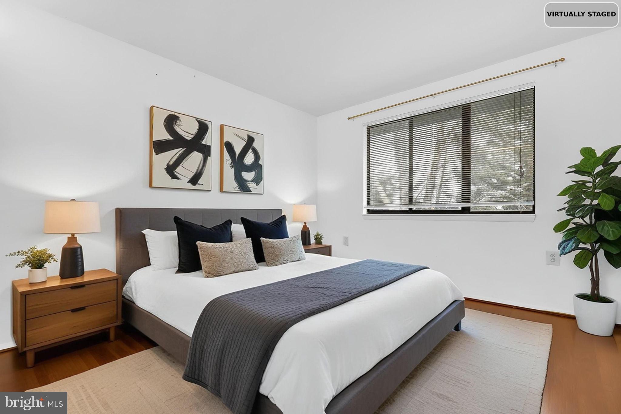 19625 Gunners Branch Road, Unit 932 Germantown, MD 20876 - Photo 14 of 21 a bedroom with a bed and a potted plant