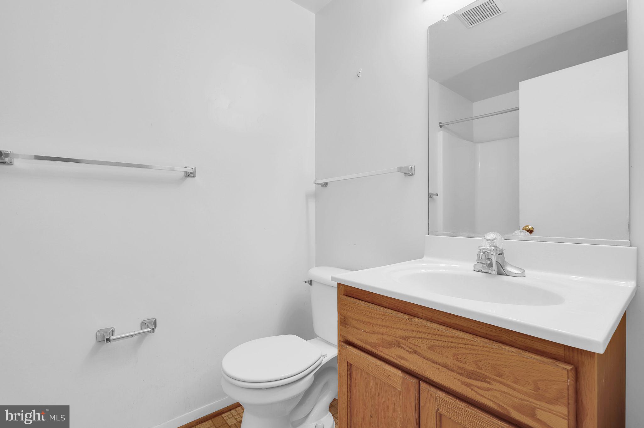 19625 Gunners Branch Road, Unit 932 Germantown, MD 20876 - Photo 16 of 21 a bathroom with a sink toilet and a mirror