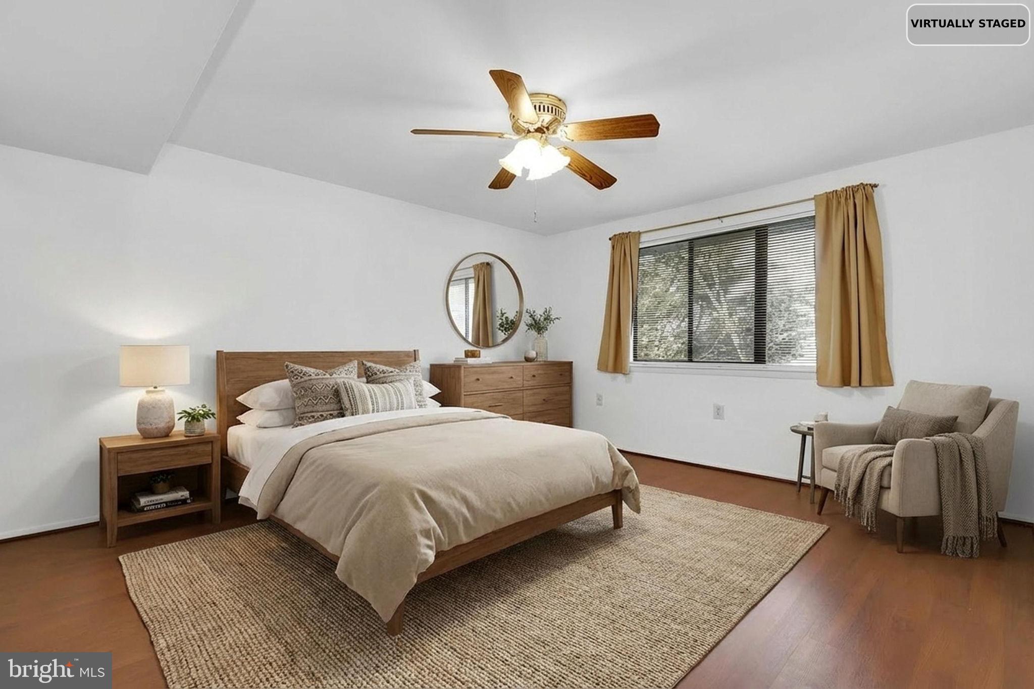 19625 Gunners Branch Road, Unit 932 Germantown, MD 20876 - Photo 18 of 21 a bedroom with a large bed and a chandelier