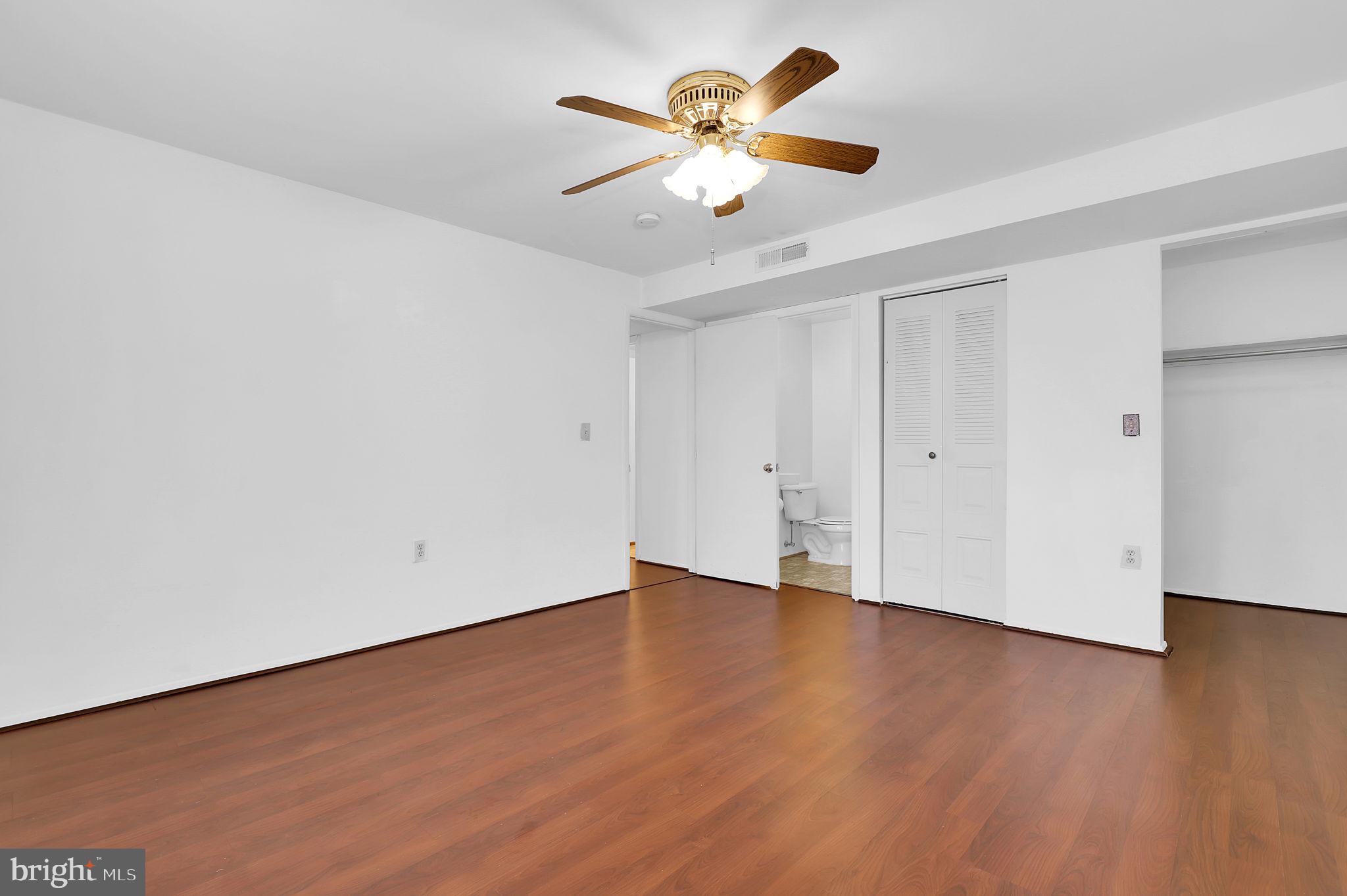 19625 Gunners Branch Road, Unit 932 Germantown, MD 20876 - Photo 19 of 21 an empty room with wooden floor and windows