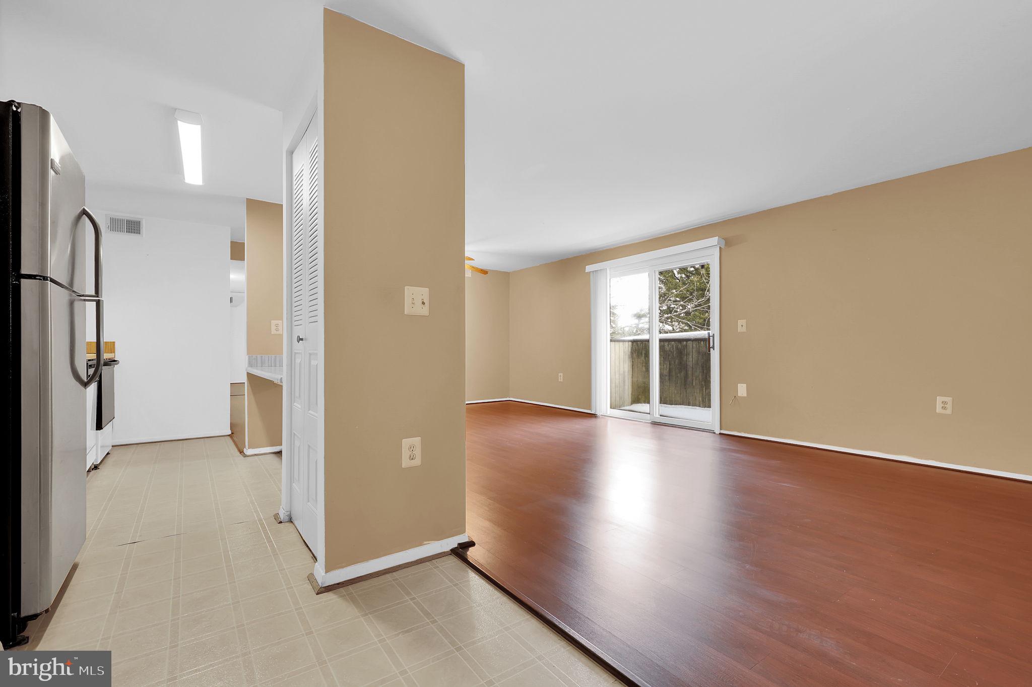 19625 Gunners Branch Road, Unit 932 Germantown, MD 20876 - Photo 2 of 21 wooden floor in an empty room with a window
