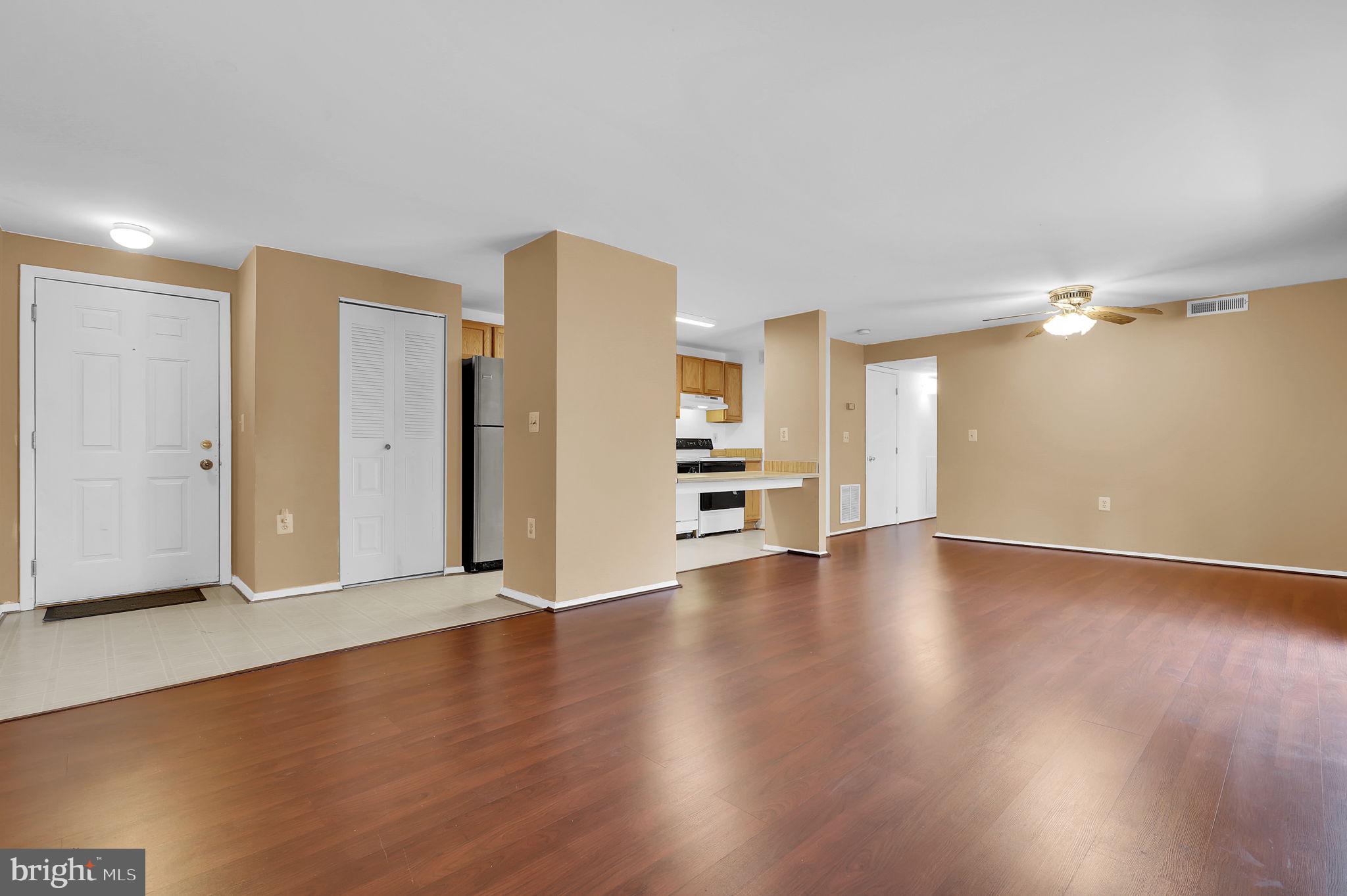 19625 Gunners Branch Road, Unit 932 Germantown, MD 20876 - Photo 3 of 21 a view of a livingroom with wooden floor