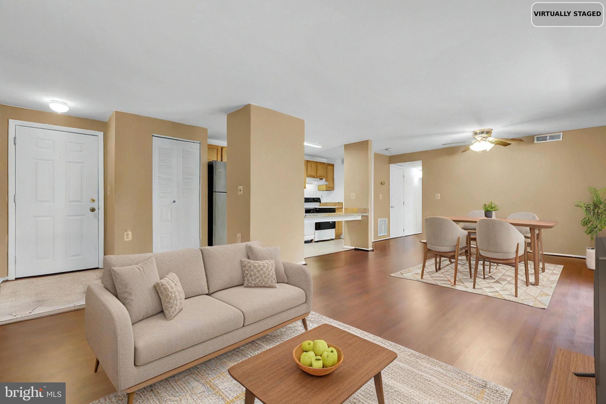 19625 Gunners Branch Road, Unit 932 Germantown, MD 20876 - Photo 4 of 21 a living room with furniture and a wooden floor