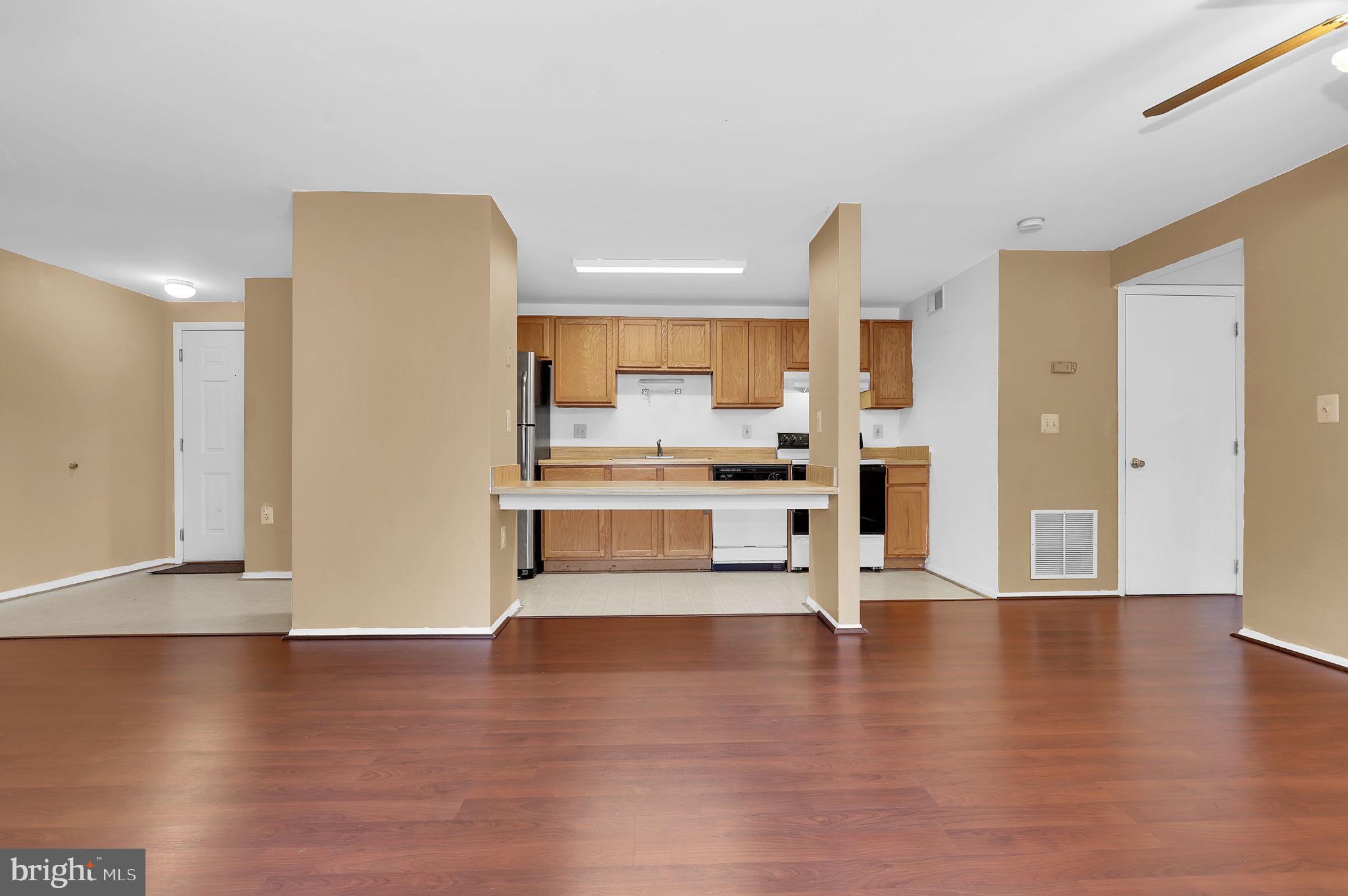 19625 Gunners Branch Road, Unit 932 Germantown, MD 20876 - Photo 6 of 21 a view of kitchen with stainless steel appliances with wooden floor