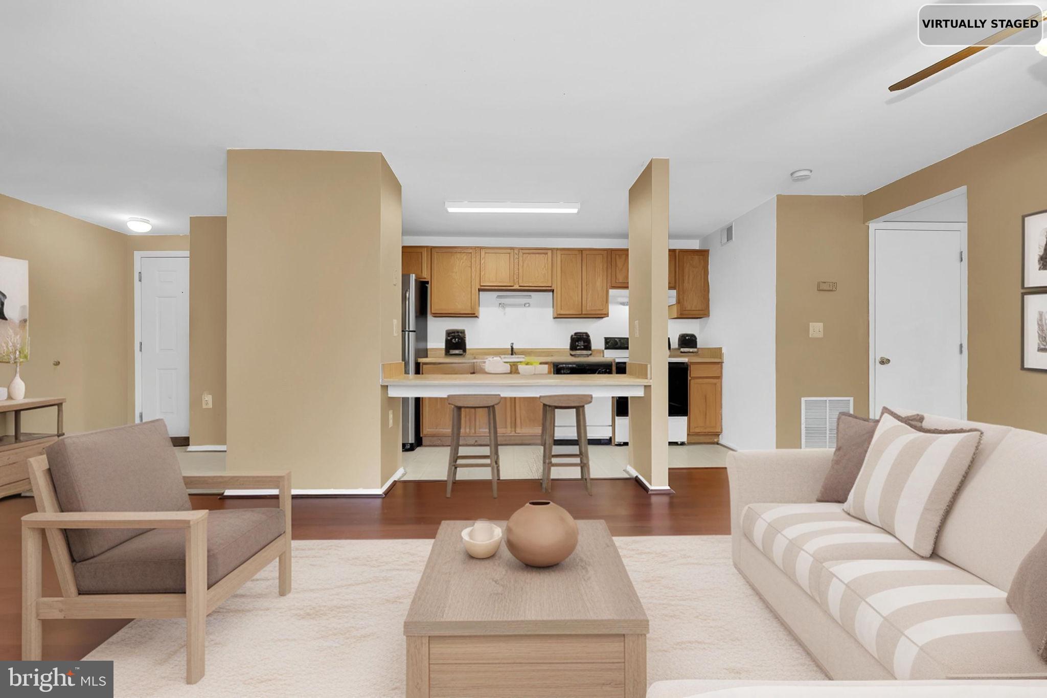 19625 Gunners Branch Road, Unit 932 Germantown, MD 20876 - Photo 7 of 21 a living room with furniture and a view of kitchen