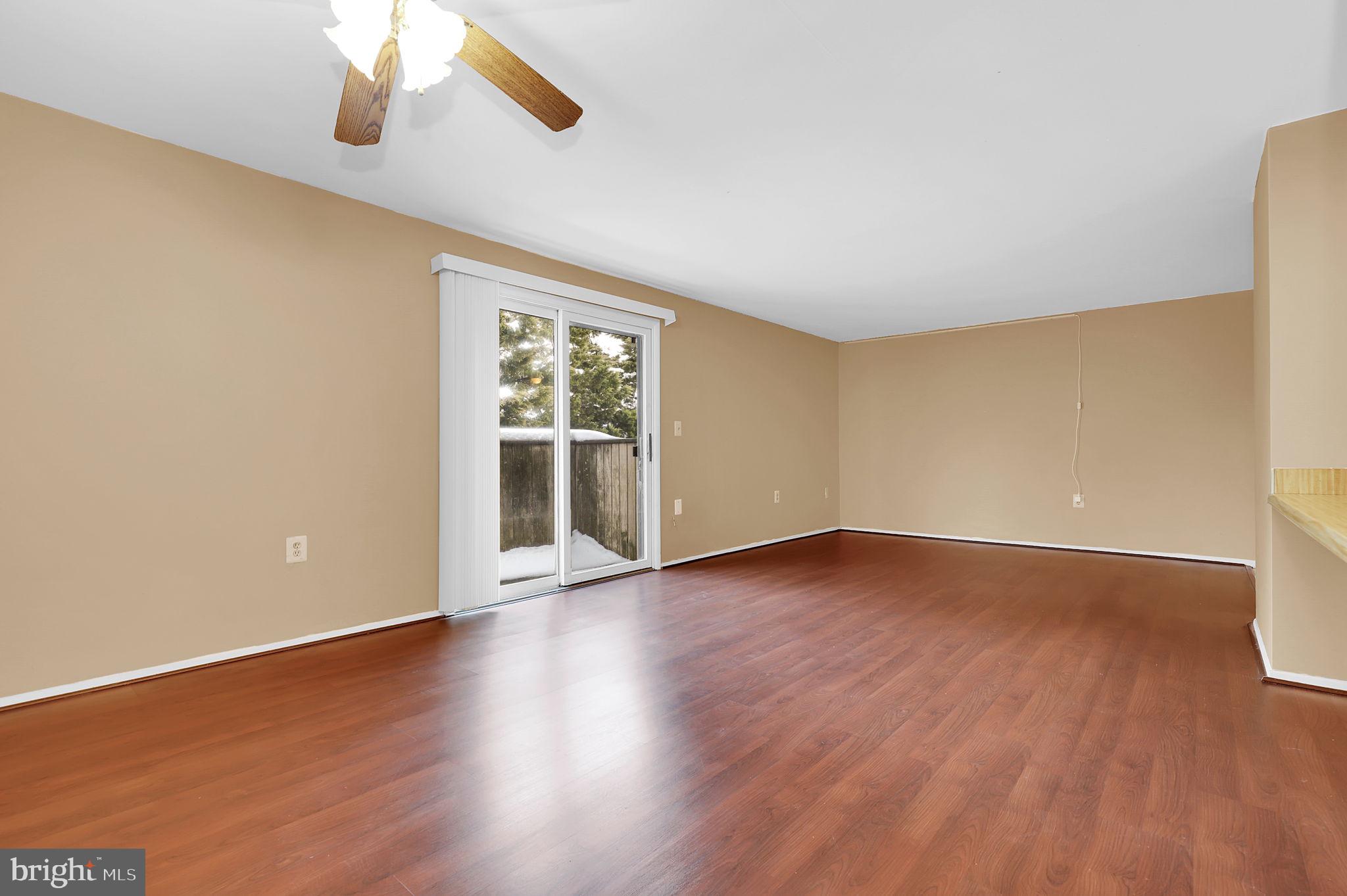 19625 Gunners Branch Road, Unit 932 Germantown, MD 20876 - Photo 8 of 21 a view of an empty room with wooden floor and a window