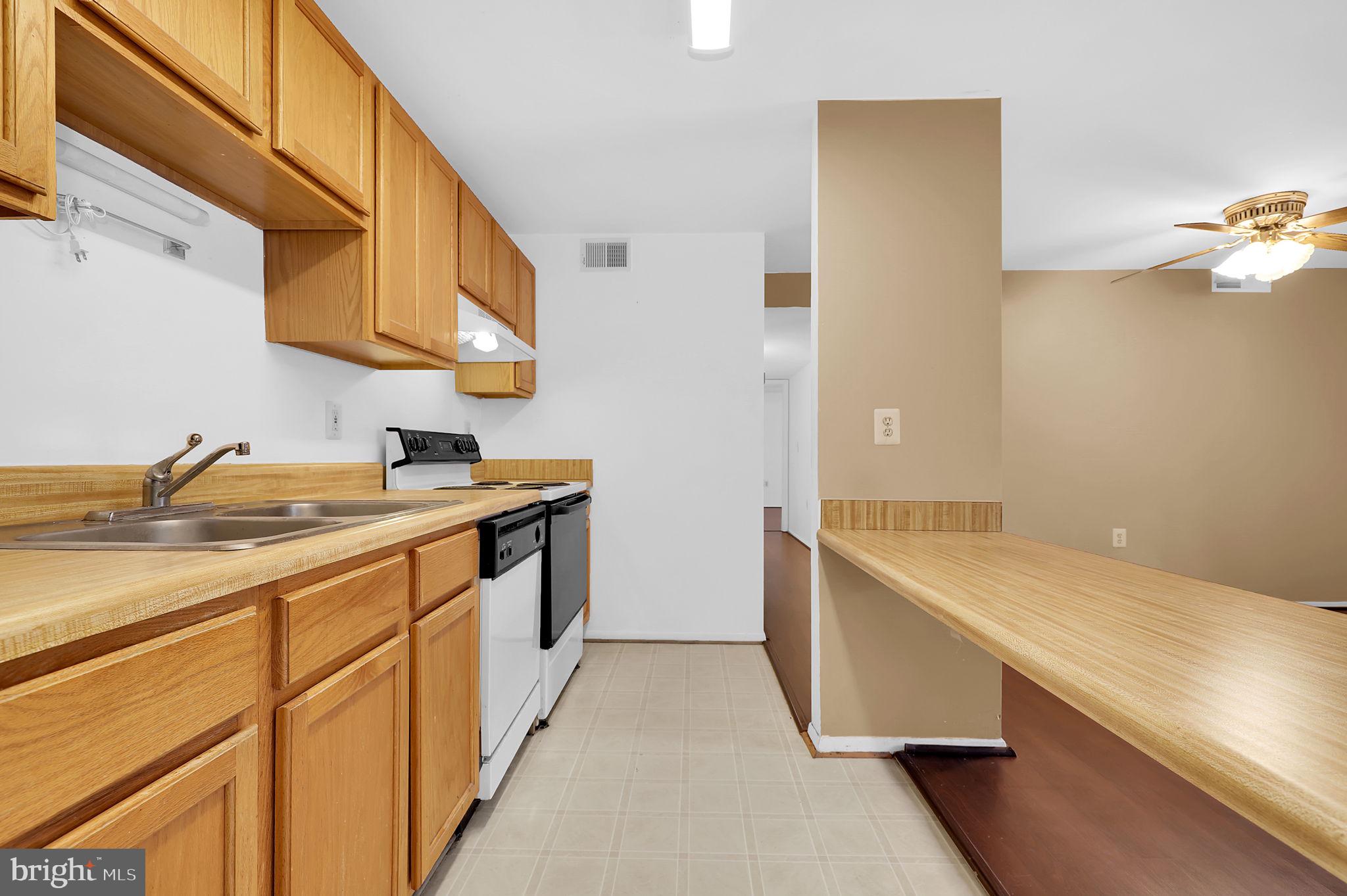 19625 Gunners Branch Road, Unit 932 Germantown, MD 20876 - Photo 10 of 21 a kitchen with a sink and a stove top oven