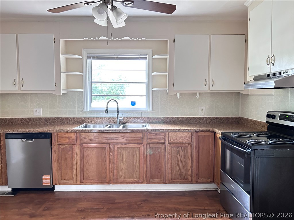 5200 Cypress Road Fayetteville, NC 28304 - Photo 4 of 9 a kitchen with granite countertop a sink stainless steel appliances and cabinets