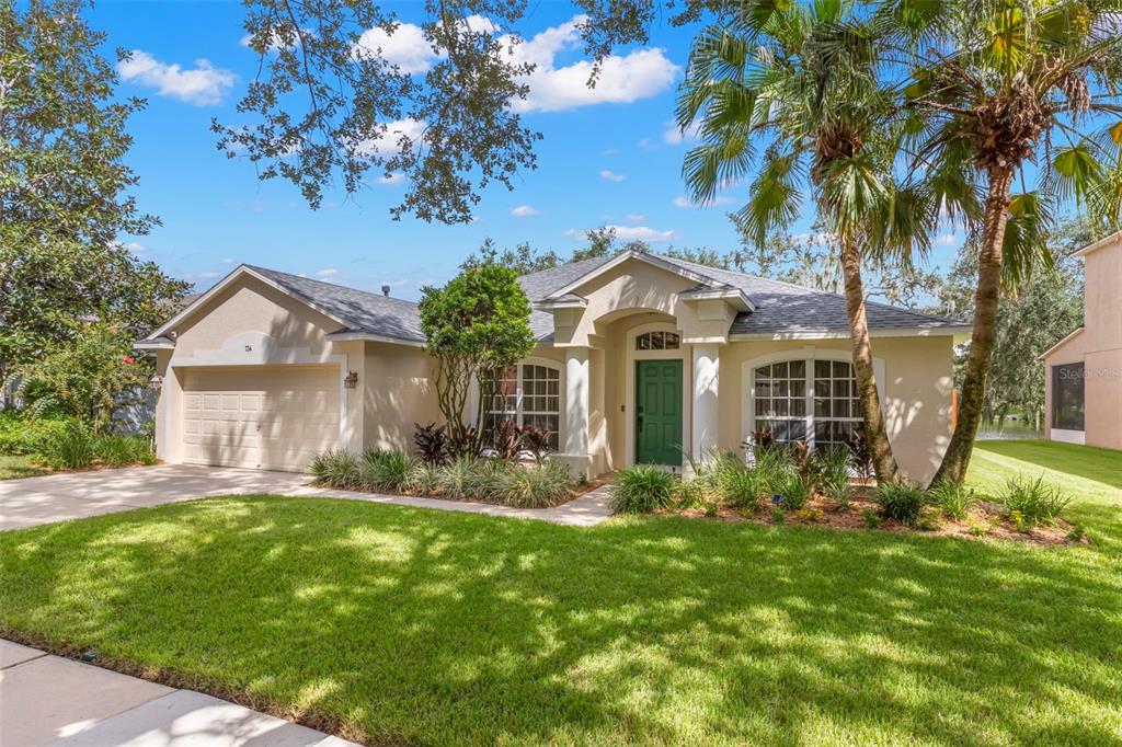 734 Berry Bramble Drive Brandon, FL 33510 - Photo 3 of 49 a front view of a house with a yard and porch