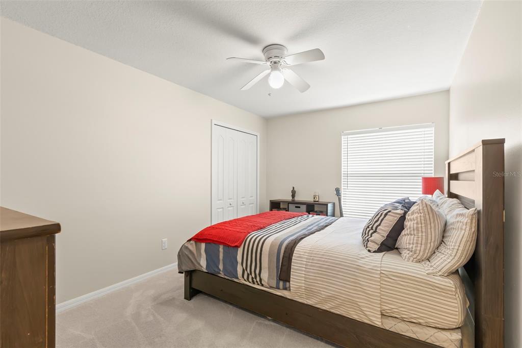 734 Berry Bramble Drive Brandon, FL 33510 - Photo 36 of 49 a bedroom with a bed and a ceiling fan