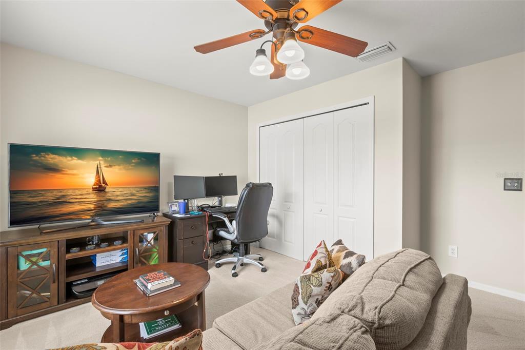 734 Berry Bramble Drive Brandon, FL 33510 - Photo 39 of 49 a work room with furniture and a flat screen tv