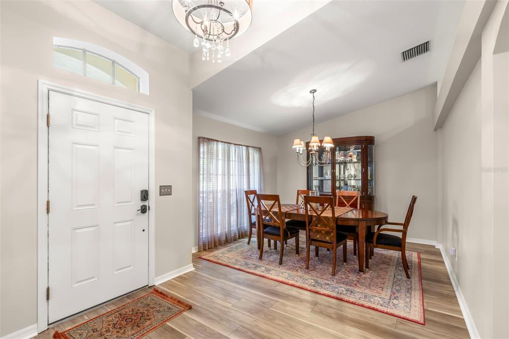 734 Berry Bramble Drive Brandon, FL 33510 - Photo 10 of 49 a view of a dining room with furniture window and wooden floor