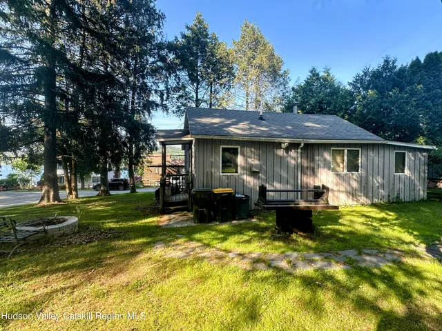 a view of a house with swimming pool and sitting area
