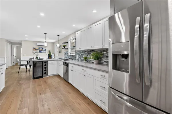 a kitchen with stainless steel appliances a refrigerator sink and cabinets