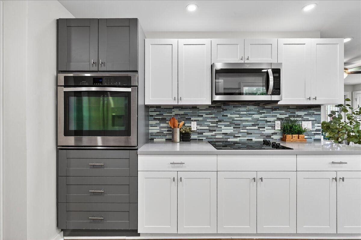 262 Easy Street Sebastian, FL 32958 - Photo 13 of 36 a kitchen with white cabinets and appliances