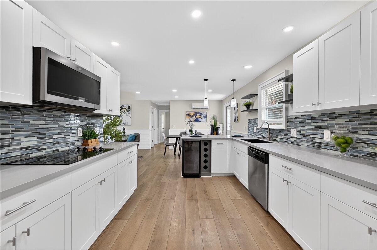 262 Easy Street Sebastian, FL 32958 - Photo 14 of 36 a large white kitchen with stainless steel appliances granite countertop lots of counter top space a sink and cabinets