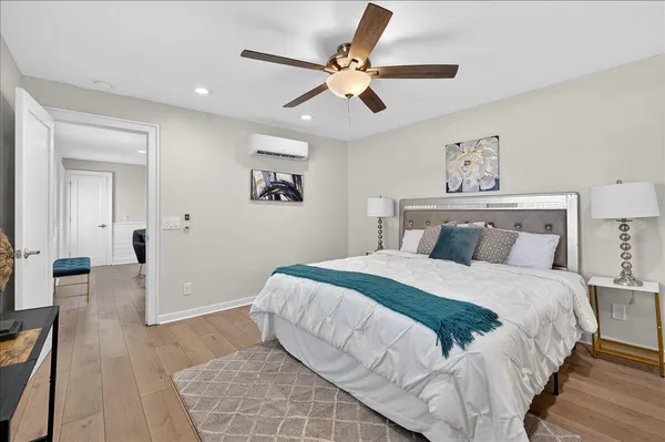 a bedroom with a bed and a ceiling fan