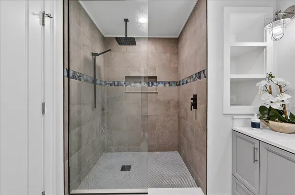 a bathroom with a shower and a sink
