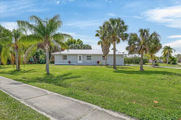 a front view of house with yard and green space