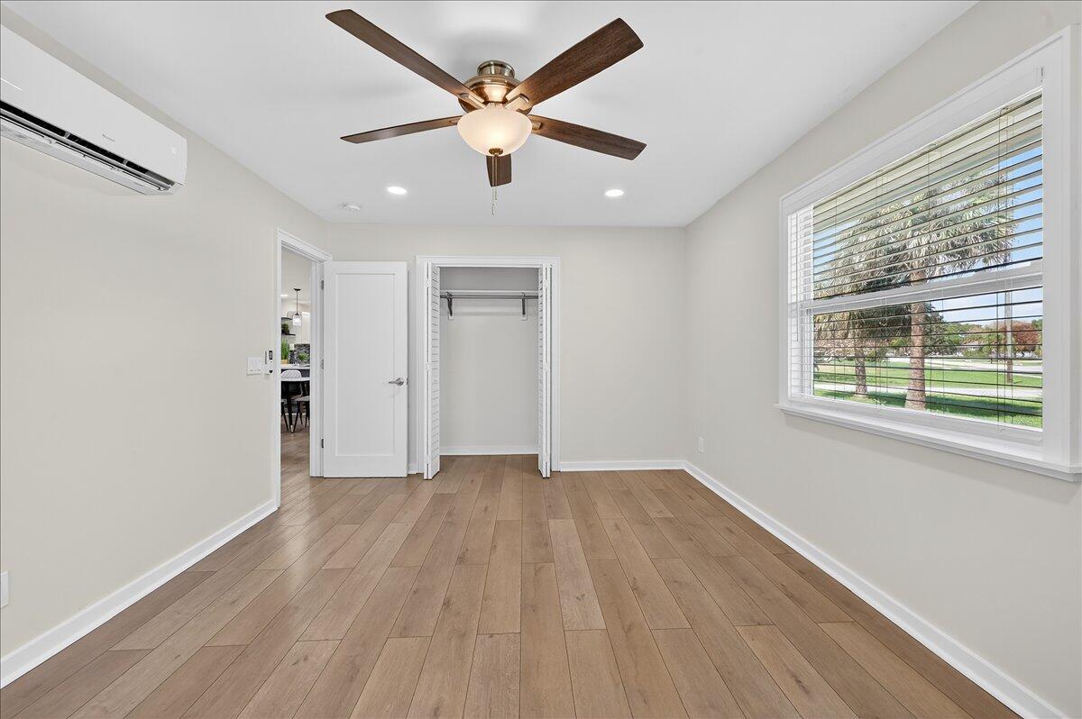 262 Easy Street Sebastian, FL 32958 - Photo 24 of 36 an empty room with wooden floor and windows