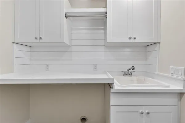 a bathroom with a sink and cabinets