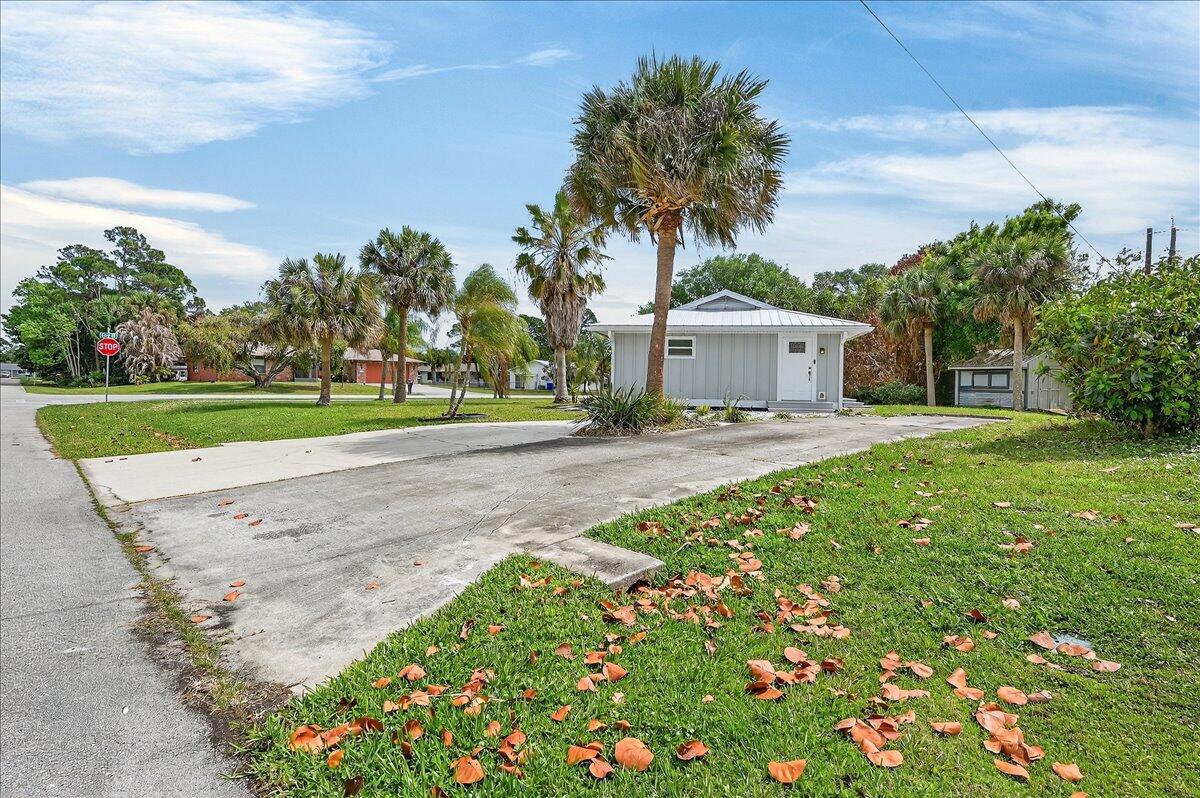 262 Easy Street Sebastian, FL 32958 - Photo 30 of 36 a front view of a house with a yard and trees