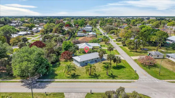 an aerial view of residential houses with outdoor space and street view