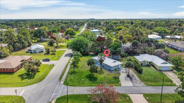 an aerial view of residential houses with outdoor space and street view